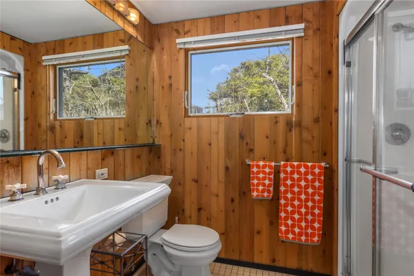 a bathroom with a sink toilet and shower