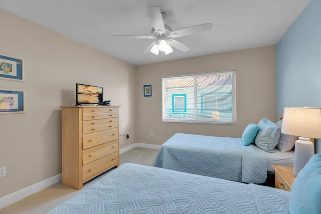a bedroom with two beds and a chandelier