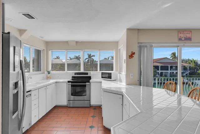 a kitchen with stainless steel appliances granite countertop a stove and a sink