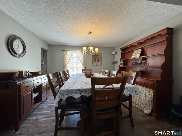 a view of hallway with a large mirror and a wooden floor