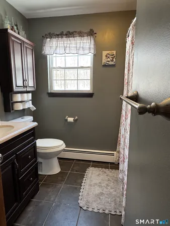 a spacious bedroom with a bed and a chandelier