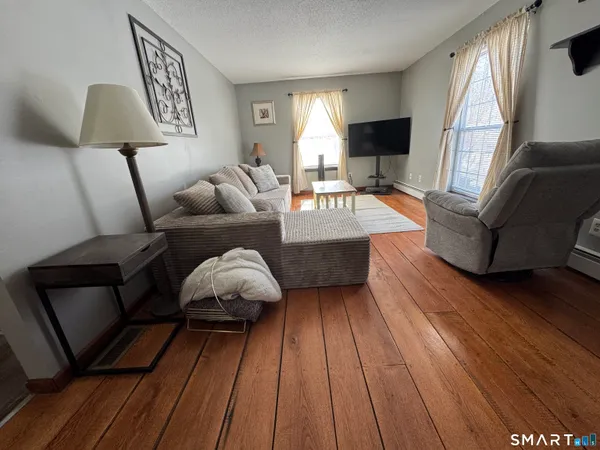 a spacious bedroom with a bed and a flat screen tv