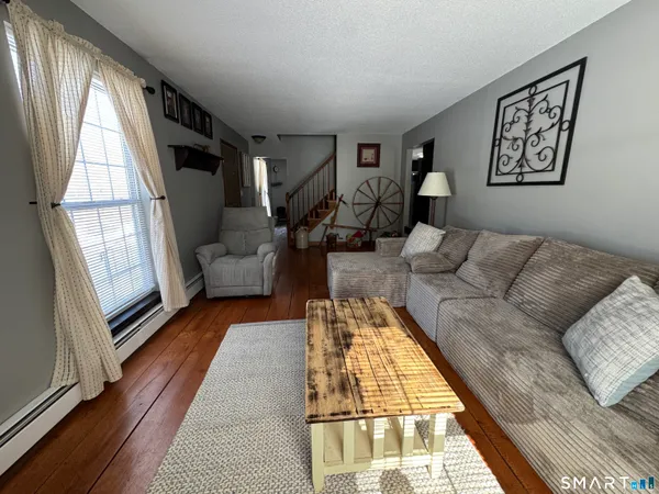 a bathroom with a toilet sink double vanity and a window