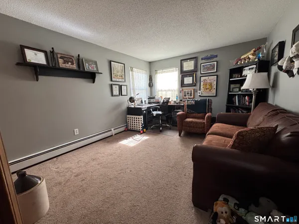 a view of bedroom with a flat tv screen and a dresser