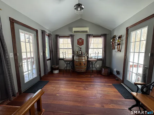 a view of a dining room with furniture and wooden floor