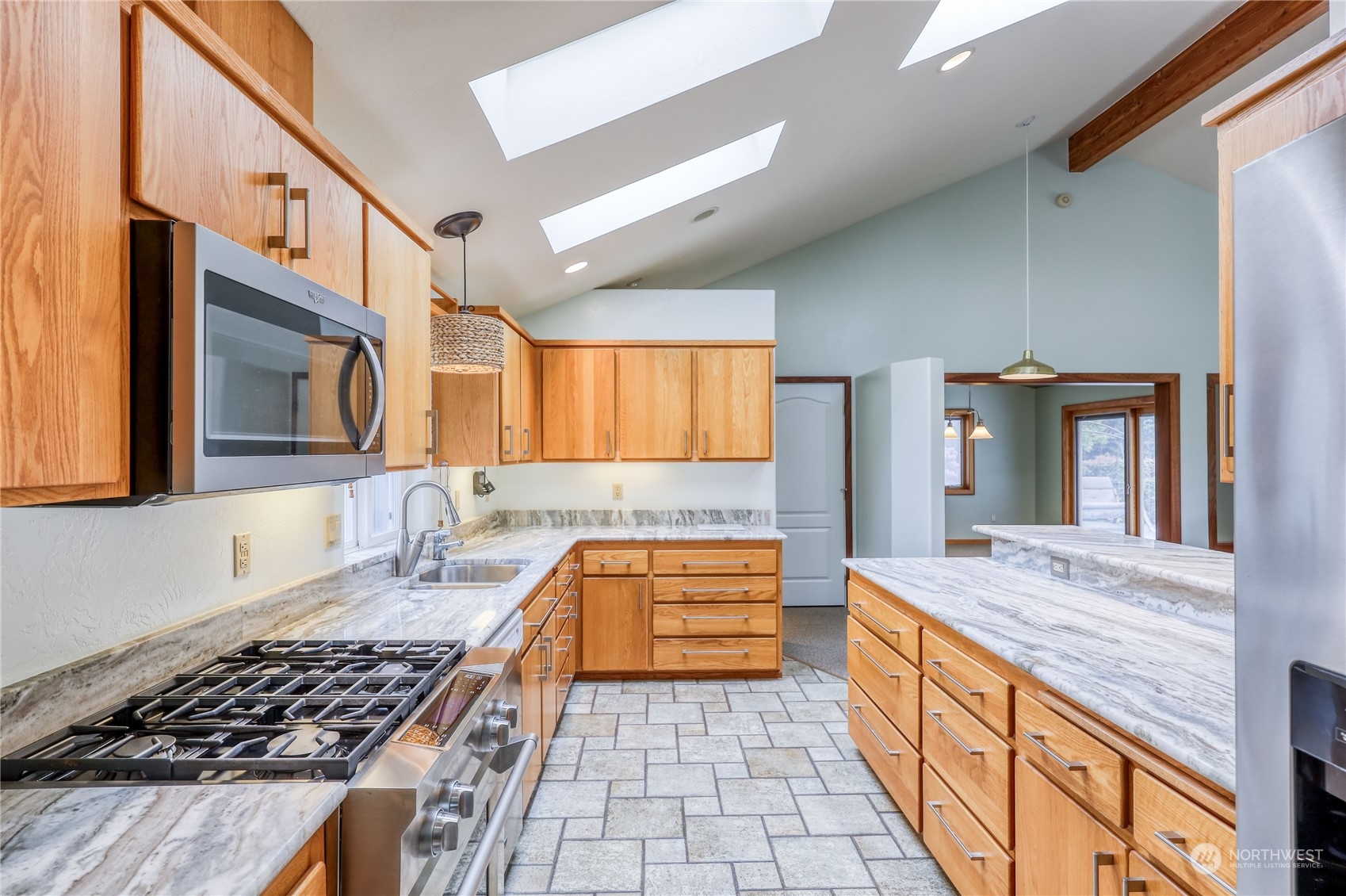 878 North Kendall Road Sequim, WA 98382 - Photo 14 of 30 a kitchen with stainless steel appliances granite countertop a stove and a sink