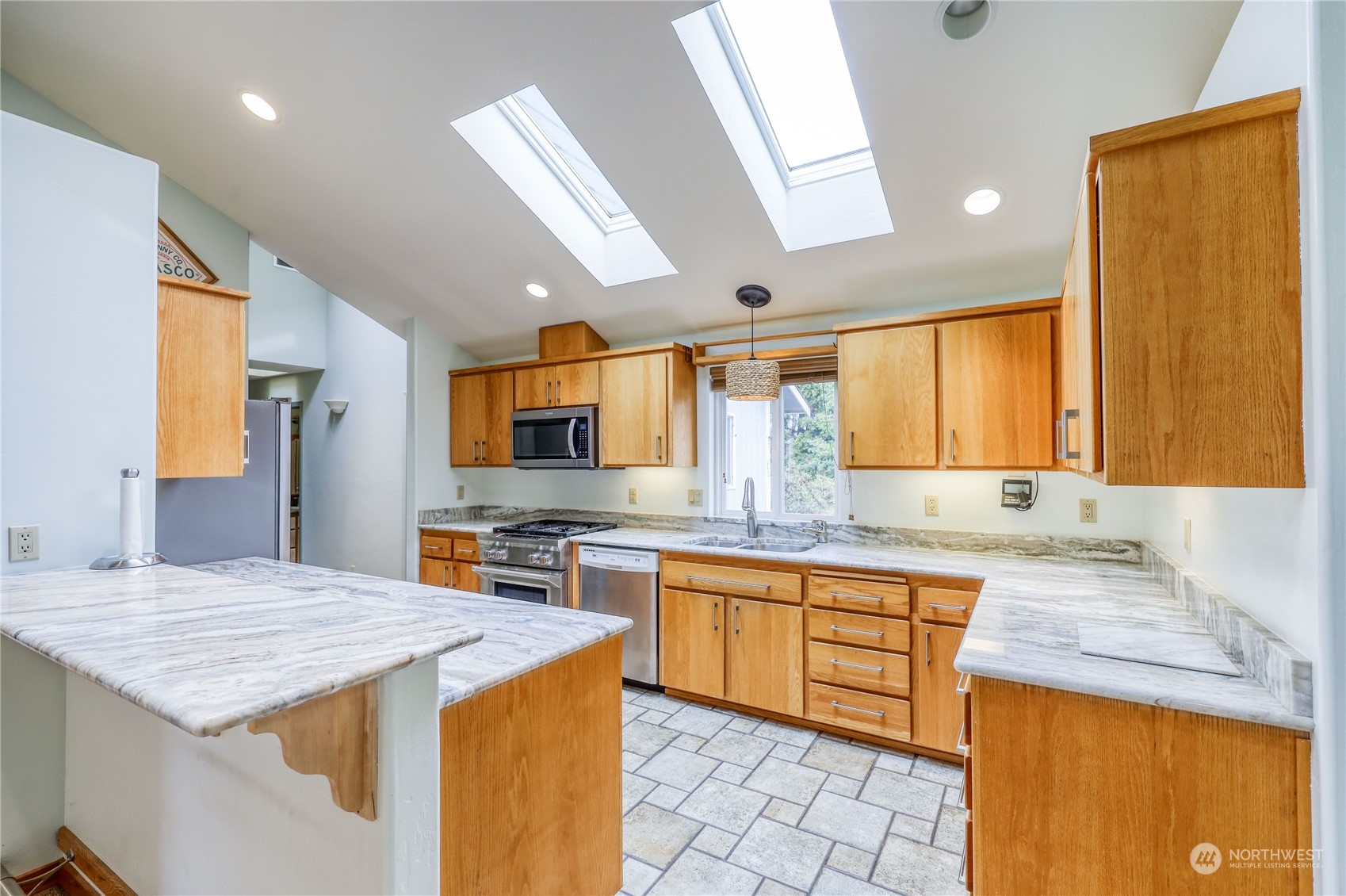 878 North Kendall Road Sequim, WA 98382 - Photo 15 of 30 a kitchen with a stove a sink a refrigerator and a microwave