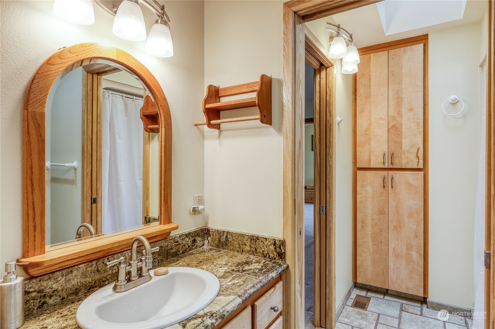 878 North Kendall Road Sequim, WA 98382 - Photo 23 of 30 a bathroom with a granite countertop sink and a mirror
