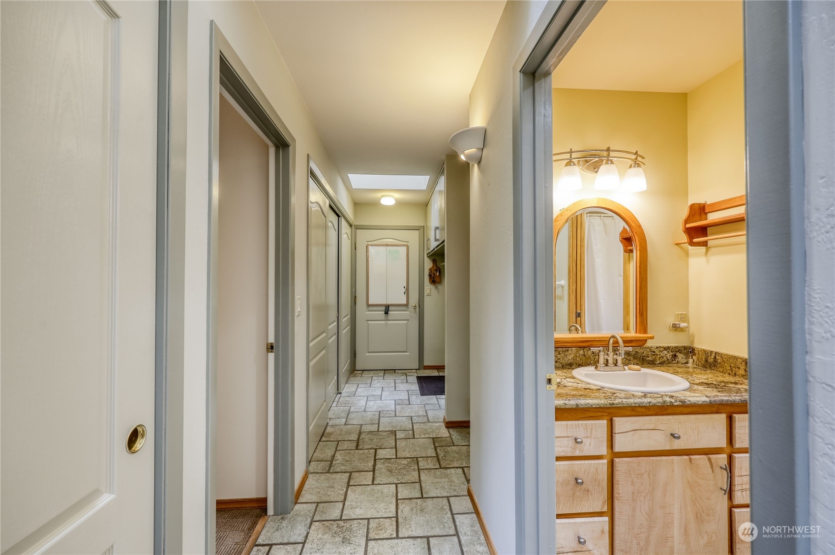 878 North Kendall Road Sequim, WA 98382 - Photo 27 of 30 a bathroom with a granite countertop sink and a mirror