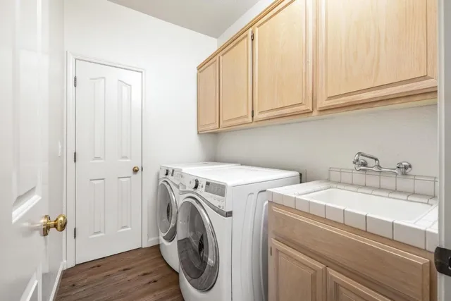 a bathroom with a granite countertop toilet sink and mirror