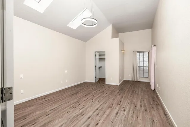 a view of walk in closet with wooden floor