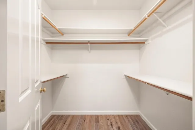 a view of a room with wooden floor