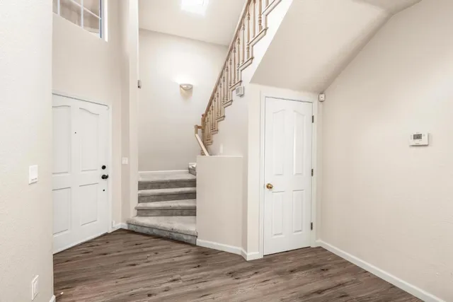 a view of hallway with chandelier fan