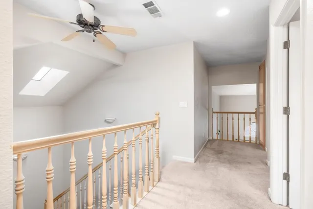 a view of hallway with bathroom