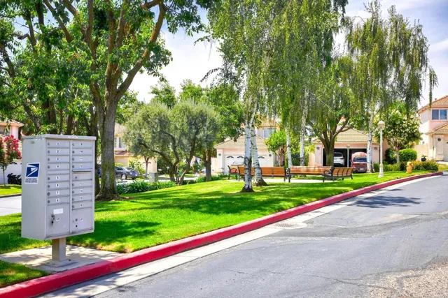an aerial view of residential houses with outdoor space and trees