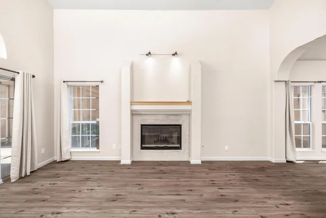 a view of a livingroom with a fireplace and window