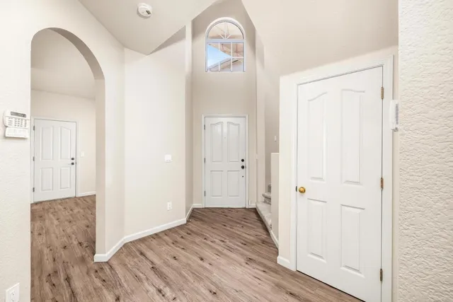 a view of empty room with wooden floor and fireplace