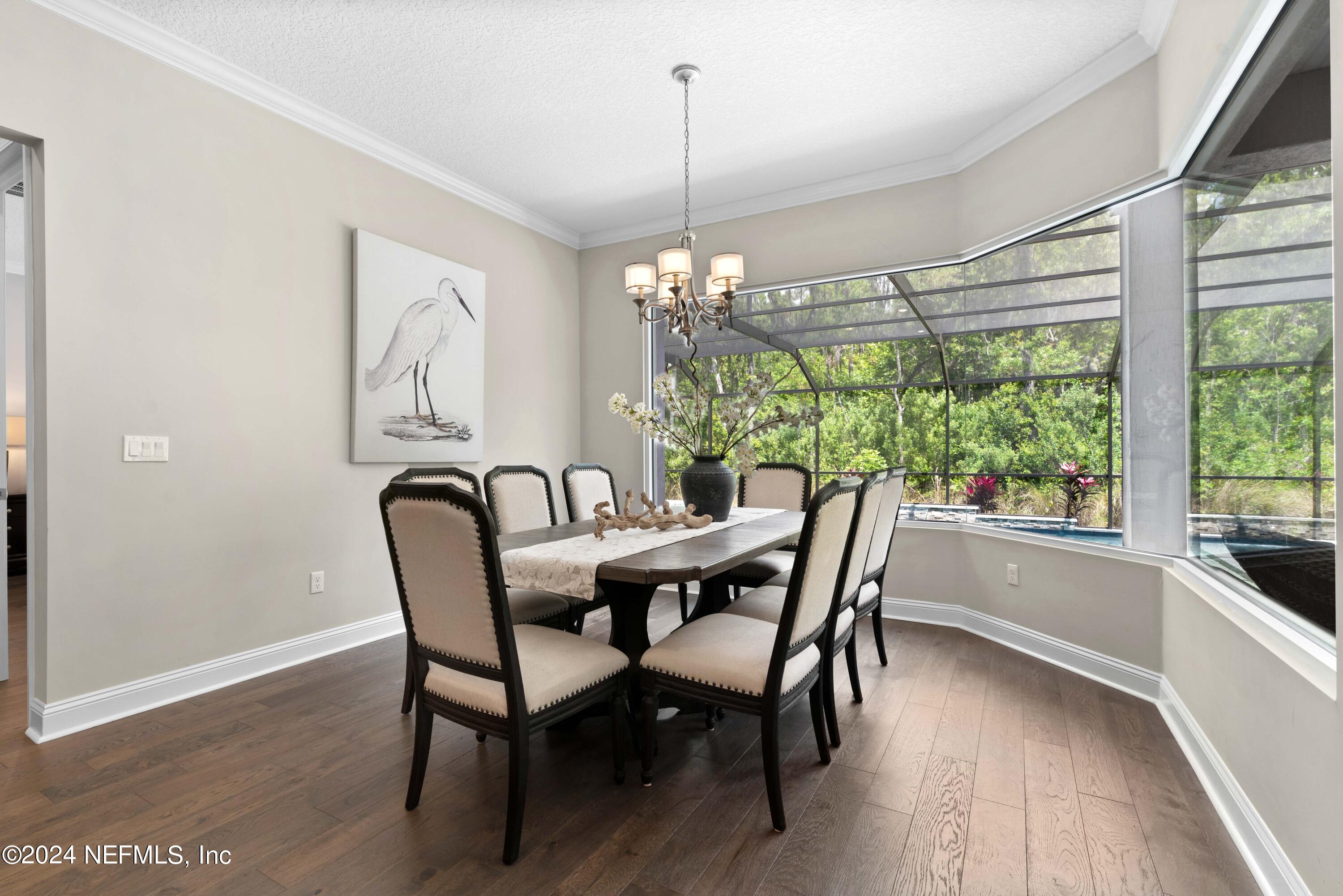 1924 Holmes Circle Fleming Island, FL 32003 - Photo 11 of 58 a dining room with furniture a chandelier and wooden floor