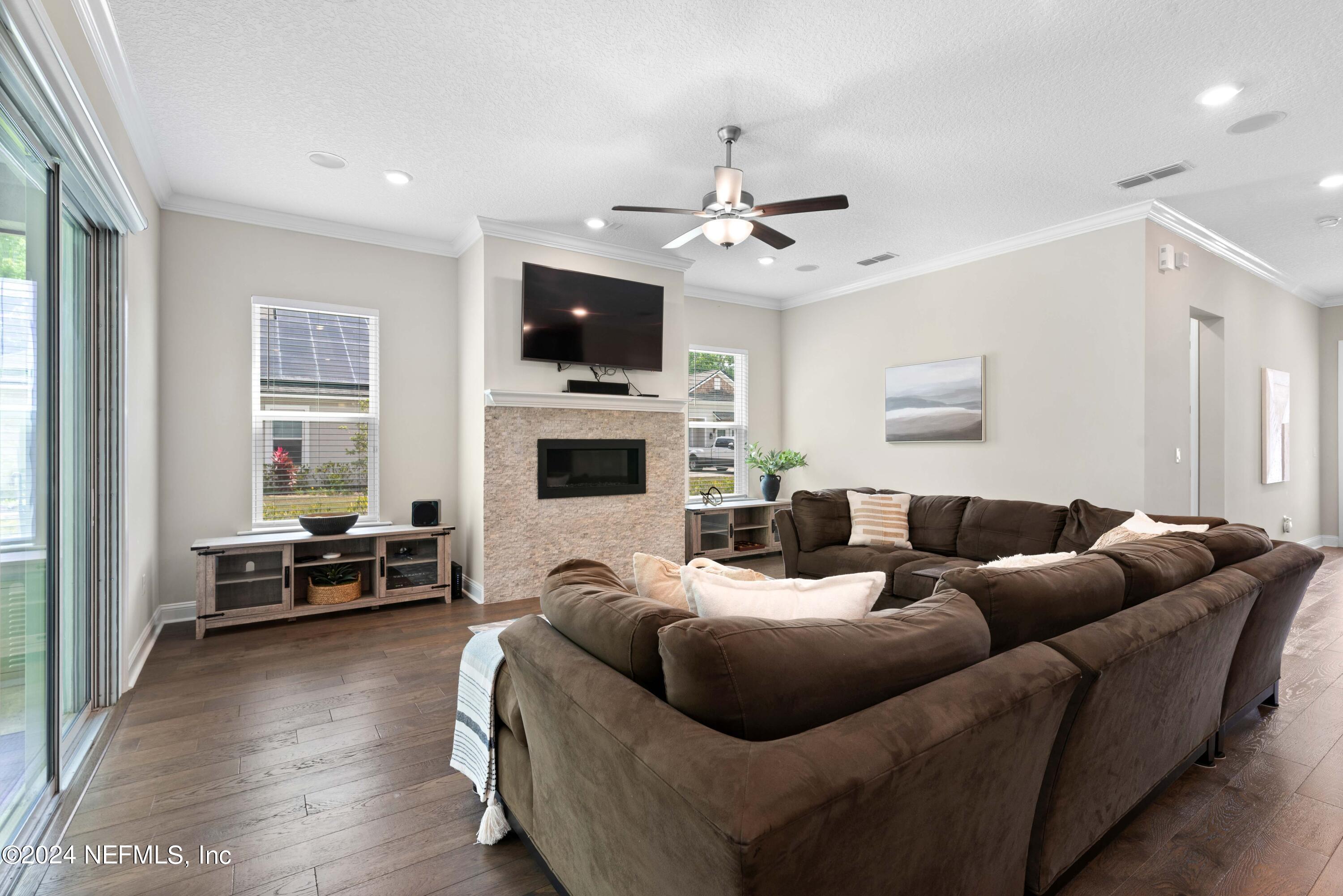 1924 Holmes Circle Fleming Island, FL 32003 - Photo 15 of 58 a living room with furniture ceiling fan and a window