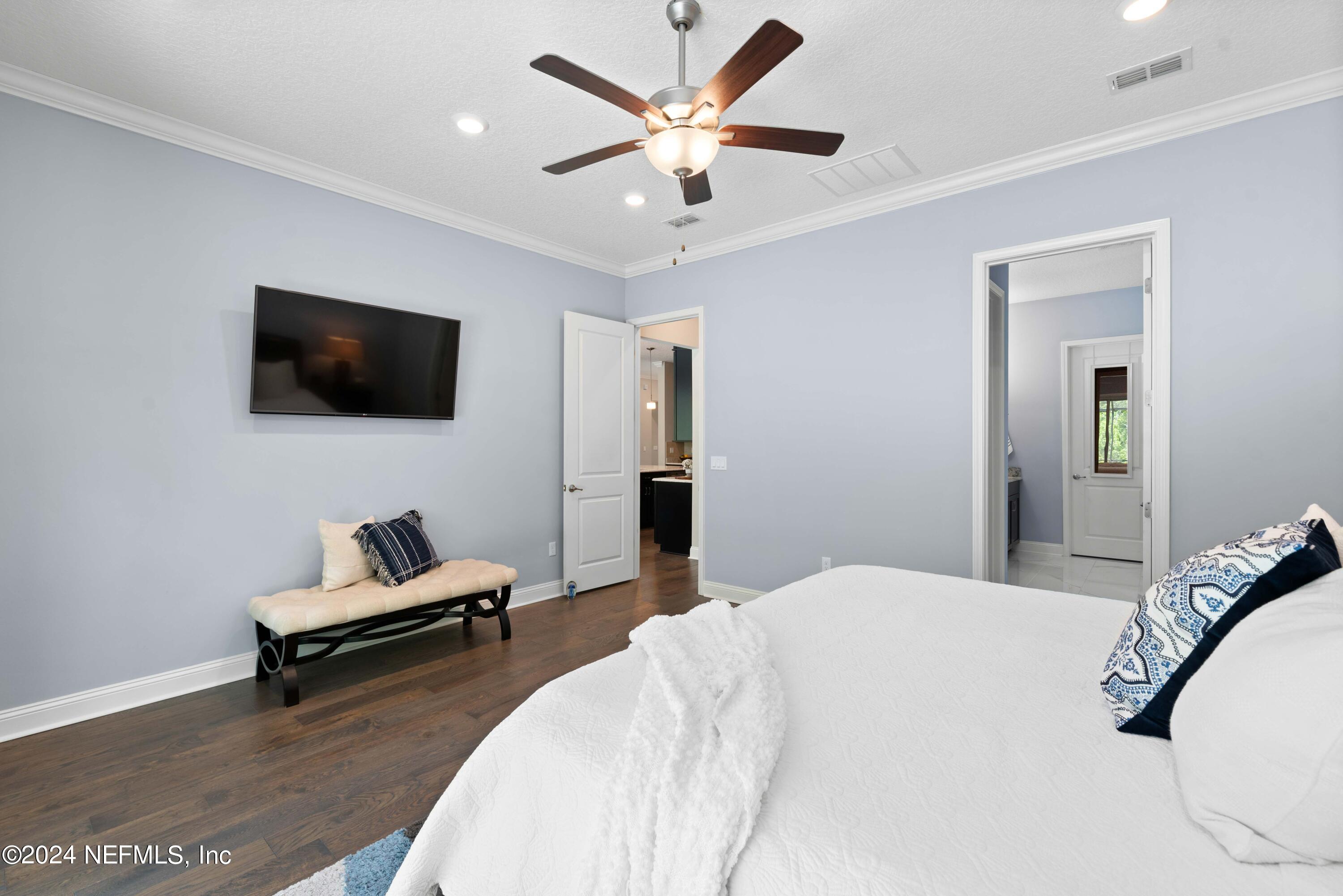 1924 Holmes Circle Fleming Island, FL 32003 - Photo 17 of 58 a bedroom with a bed and a flat screen tv