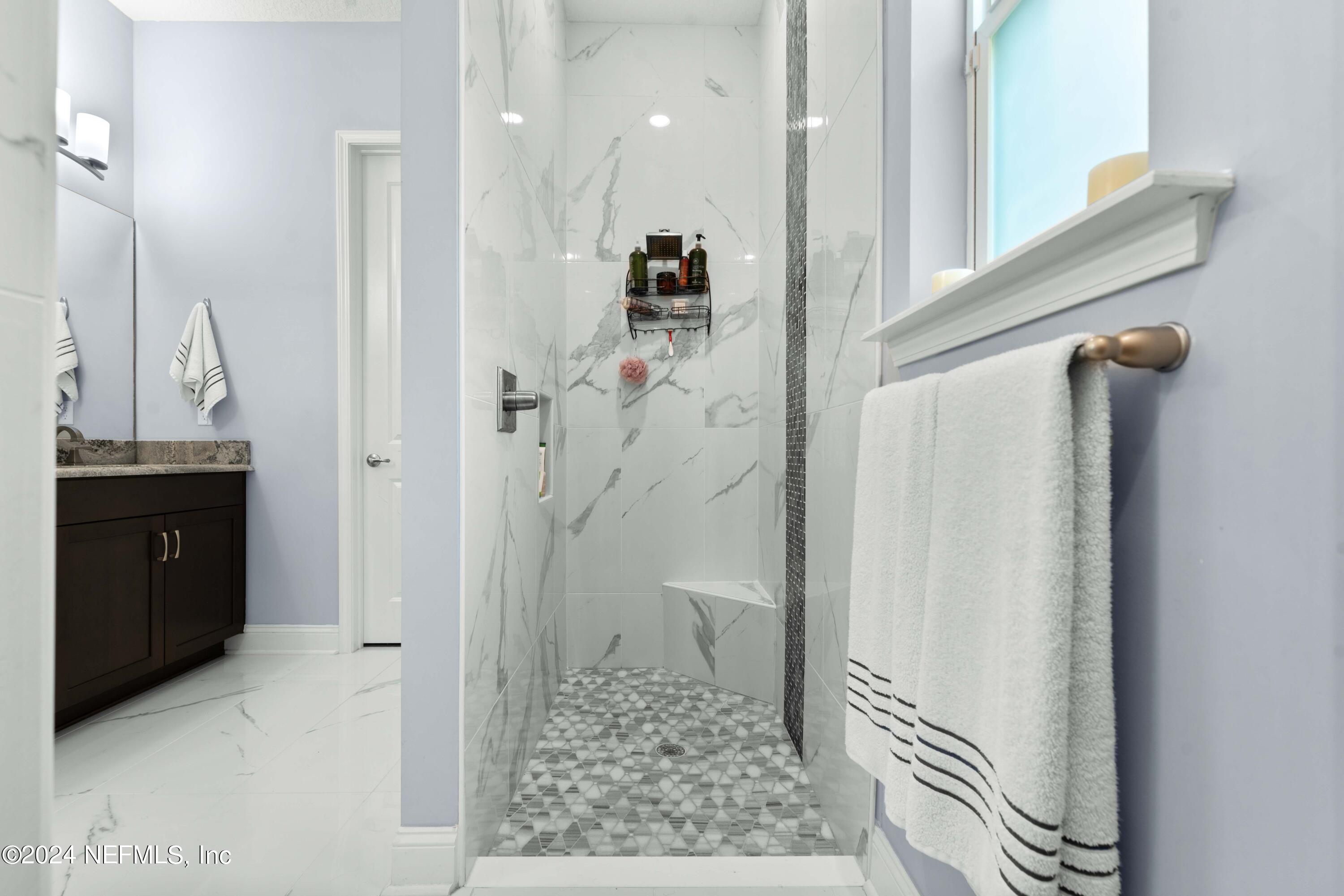 1924 Holmes Circle Fleming Island, FL 32003 - Photo 20 of 58 a bathroom with a granite countertop shower