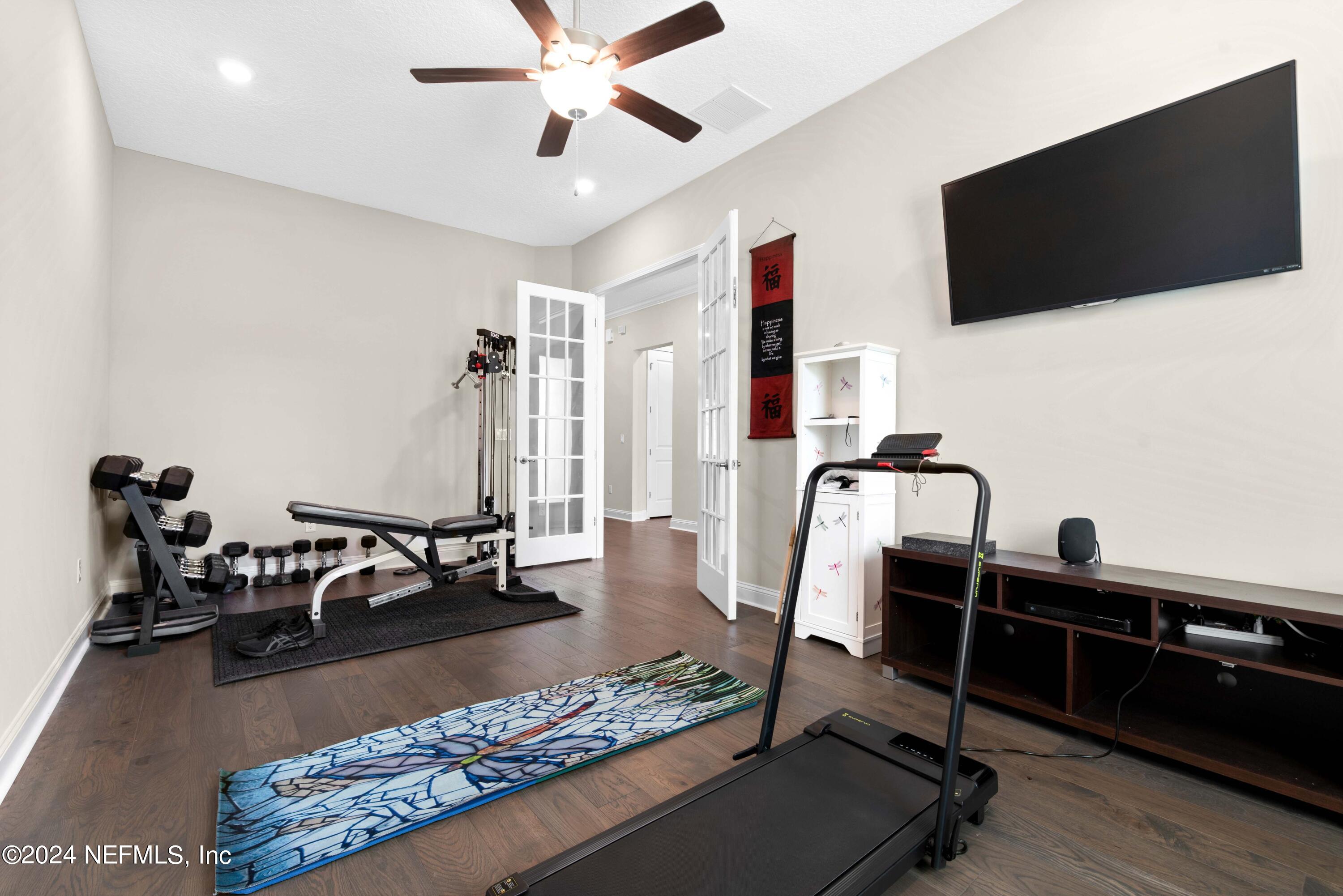 1924 Holmes Circle Fleming Island, FL 32003 - Photo 23 of 58 a living room with furniture and a flat screen tv