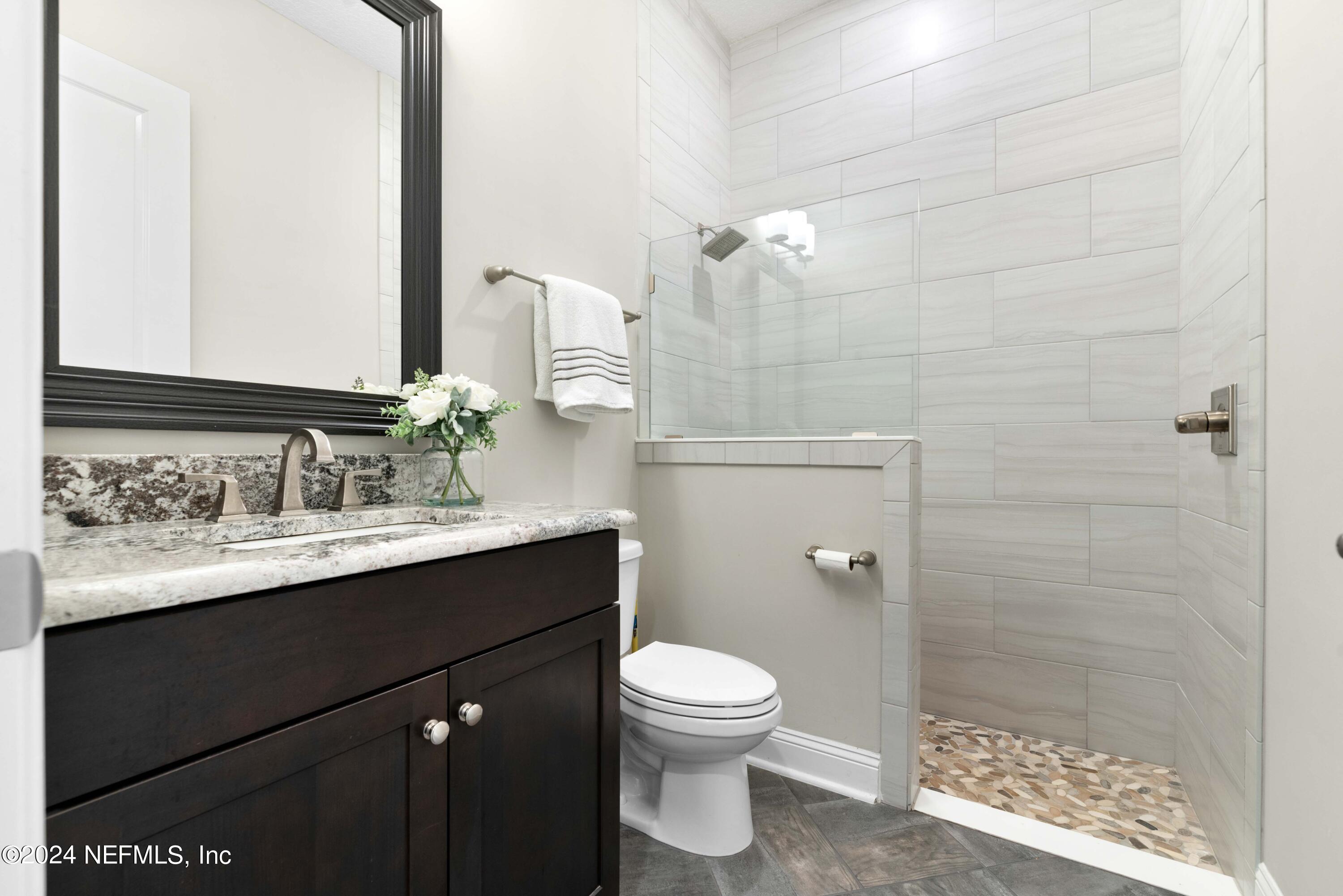 1924 Holmes Circle Fleming Island, FL 32003 - Photo 25 of 58 a bathroom with a sink and a mirror