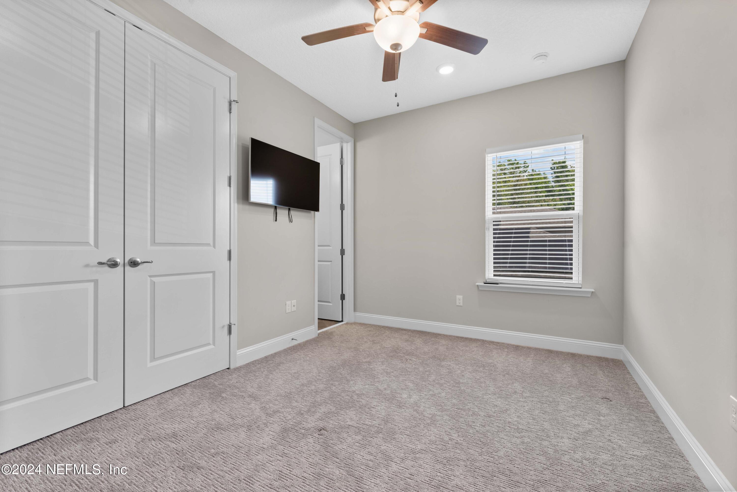 1924 Holmes Circle Fleming Island, FL 32003 - Photo 33 of 58 en empty room with ceiling fan and window