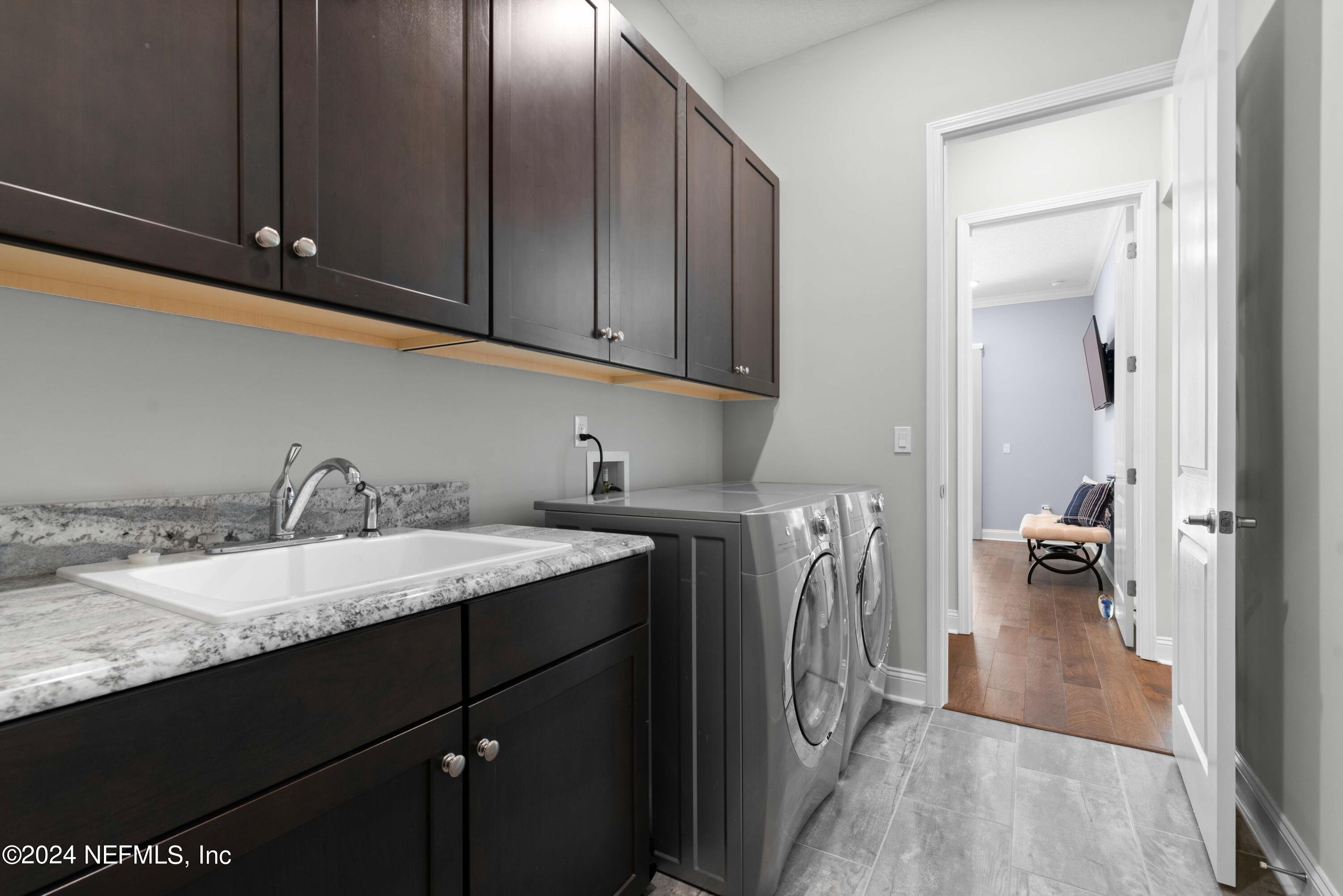 1924 Holmes Circle Fleming Island, FL 32003 - Photo 34 of 58 a utility room with cabinets