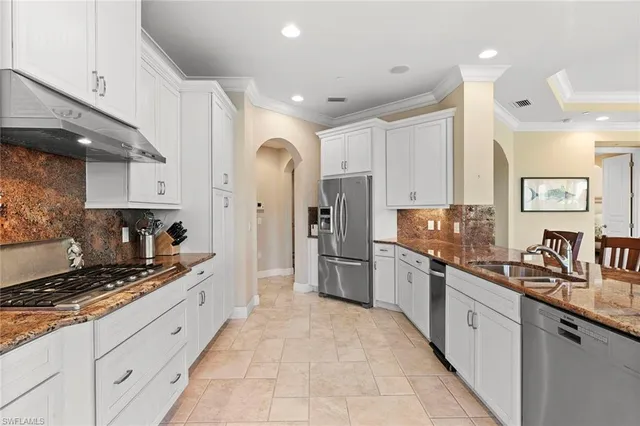 a large kitchen with stainless steel appliances lots of counter space sink and cabinets