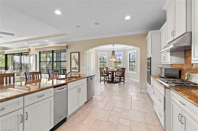 a large white kitchen with a large window