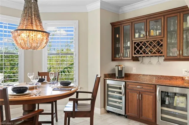 a kitchen with stainless steel appliances a table and chairs in it