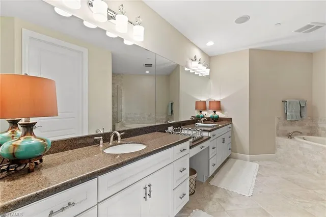 a bathroom with a sink double vanity and a mirror