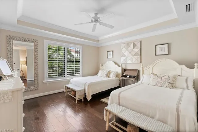 a bedroom with two beds and a large window