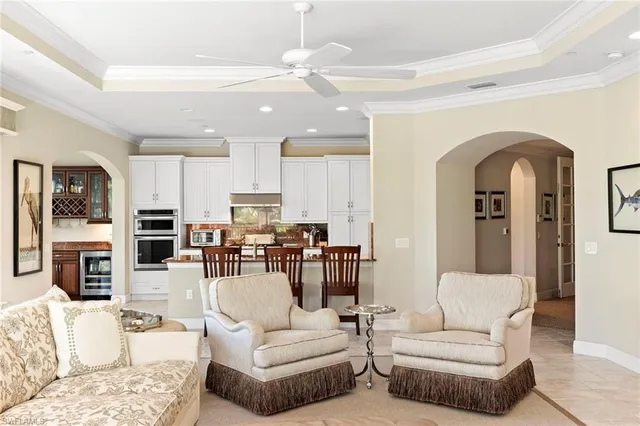 a living room with furniture a fireplace and kitchen view