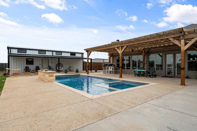 a view of a patio with swimming pool