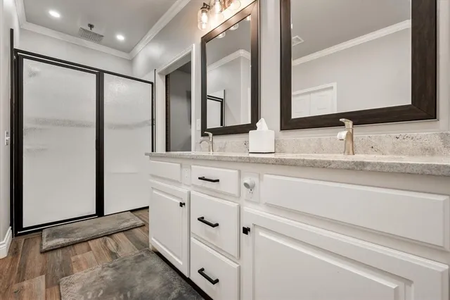 a bathroom with double vanity sink and mirror