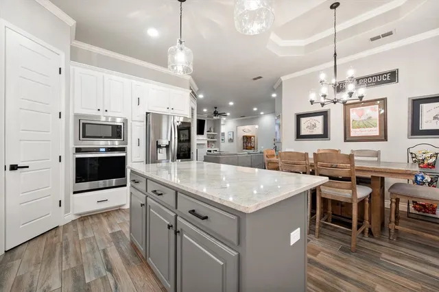 a kitchen with a sink cabinets and window