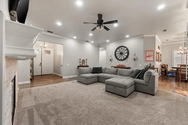 a living room with couches and a large mirror with wooden floor