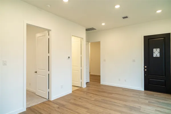 a view of hallway with wooden floor
