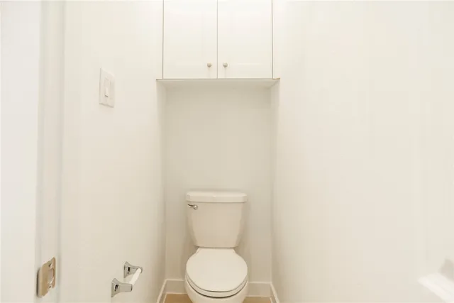 a bathroom with a sink a toilet and vanity