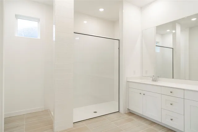 a bathroom with a double vanity sink and mirror