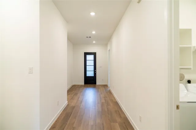 a view of hallway with wooden floor