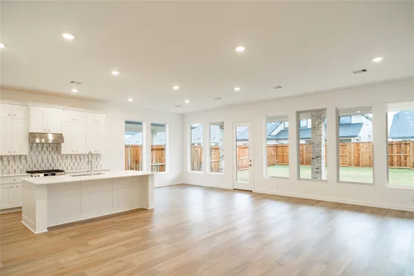 a kitchen with stainless steel appliances granite countertop a sink and cabinets