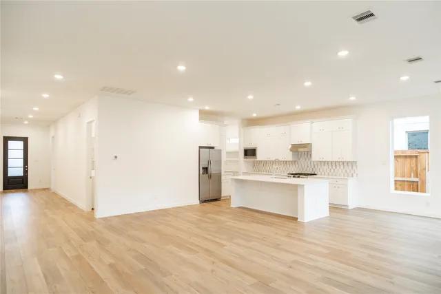 a view of kitchen with wooden floor and windows
