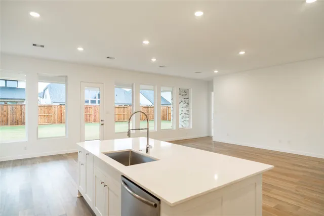 a kitchen with a sink and large window