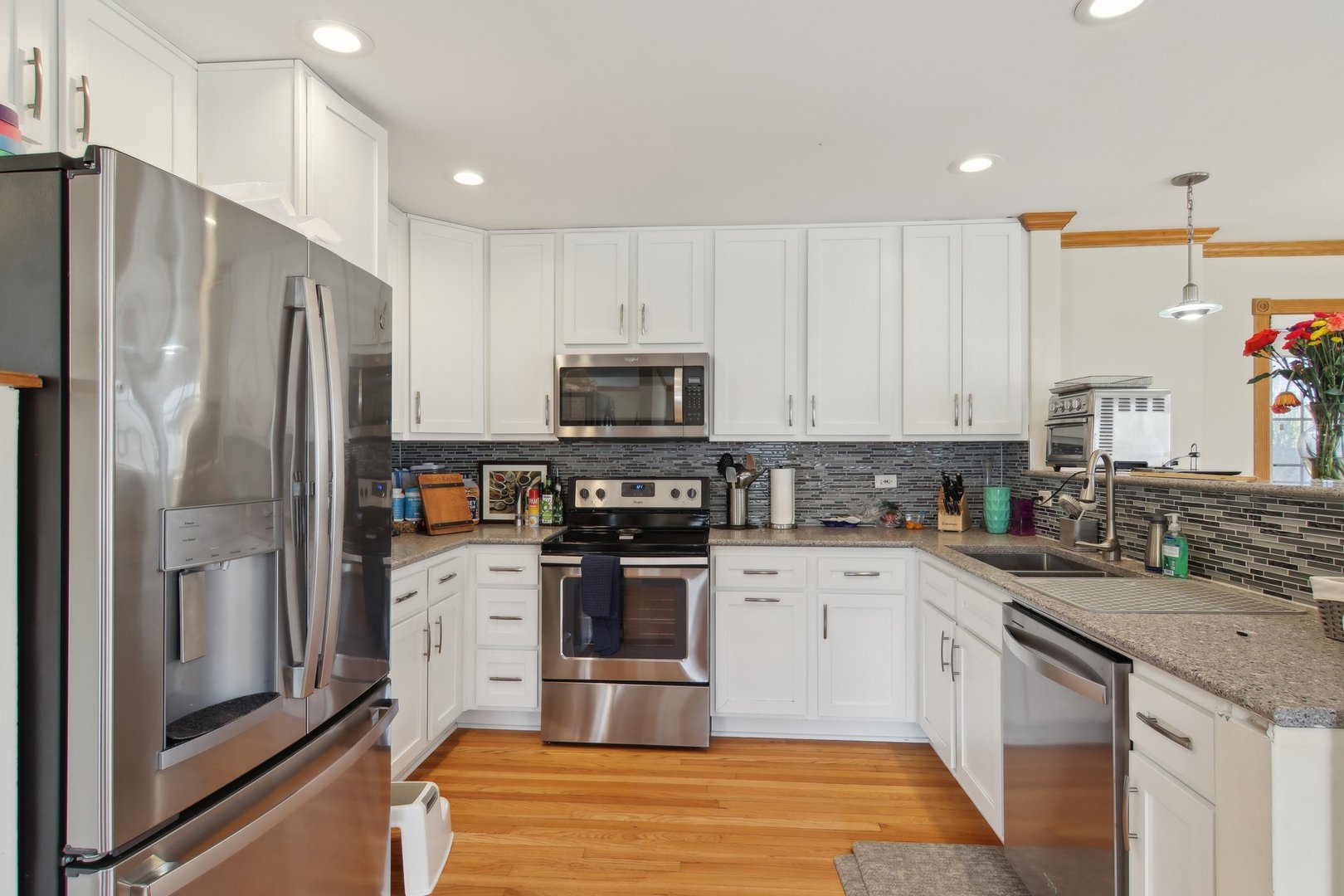 1115 Whitfield Road Northbrook, IL 60062 - Photo 12 of 54 a kitchen with a sink stainless steel appliances and white cabinets