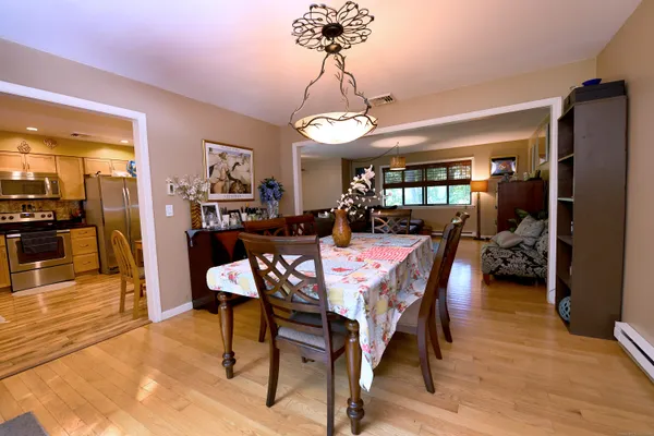 a view of a dining room with furniture and wooden floor