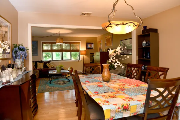 a view of a dining room with furniture and a chandelier