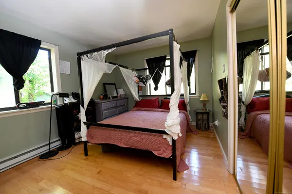 a bedroom with furniture and a window